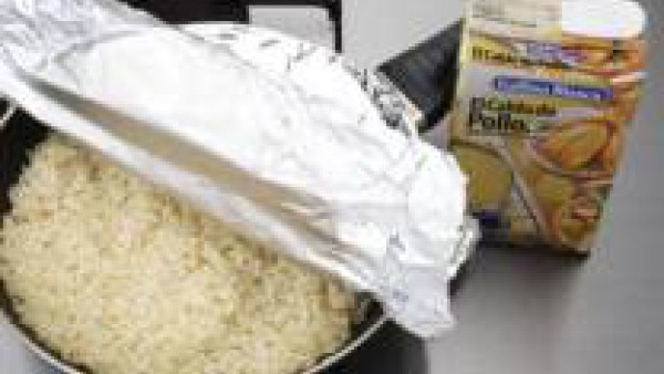 Rehoga el arroz con los ajos en el aceite caliente e incorpora el Caldo Casero de Pollo 100% Natural Gallina Blanca