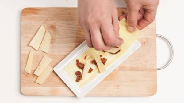 Extiende las láminas de la Lasaña Fácil el Pavo los platos y alterna la pasta con el queso de vaca y los tomates y el Tomate Frito Gallina Blanca. Termina con una capa de pasta, queso parmesano rallad
