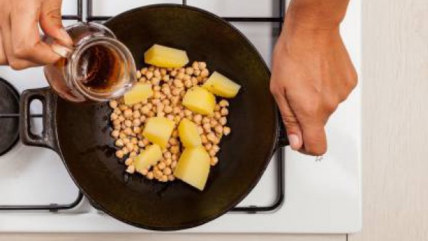 En una olla grande, cocina los garbanzos y las patatas con una hoja de laurel, agua y 1 pastilla de Avecrem Verduras -30% de Sal desmenuzada durante 30 minutos.