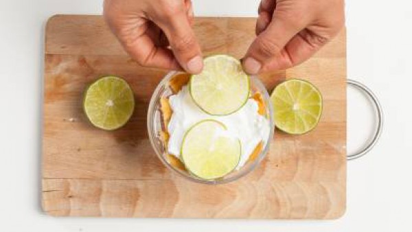 Cubre la última capa de tiramisú con rodajas de limón y nata montada. Guarda en el refrigerador durante por lo menos 1 hora y luego sirve. 